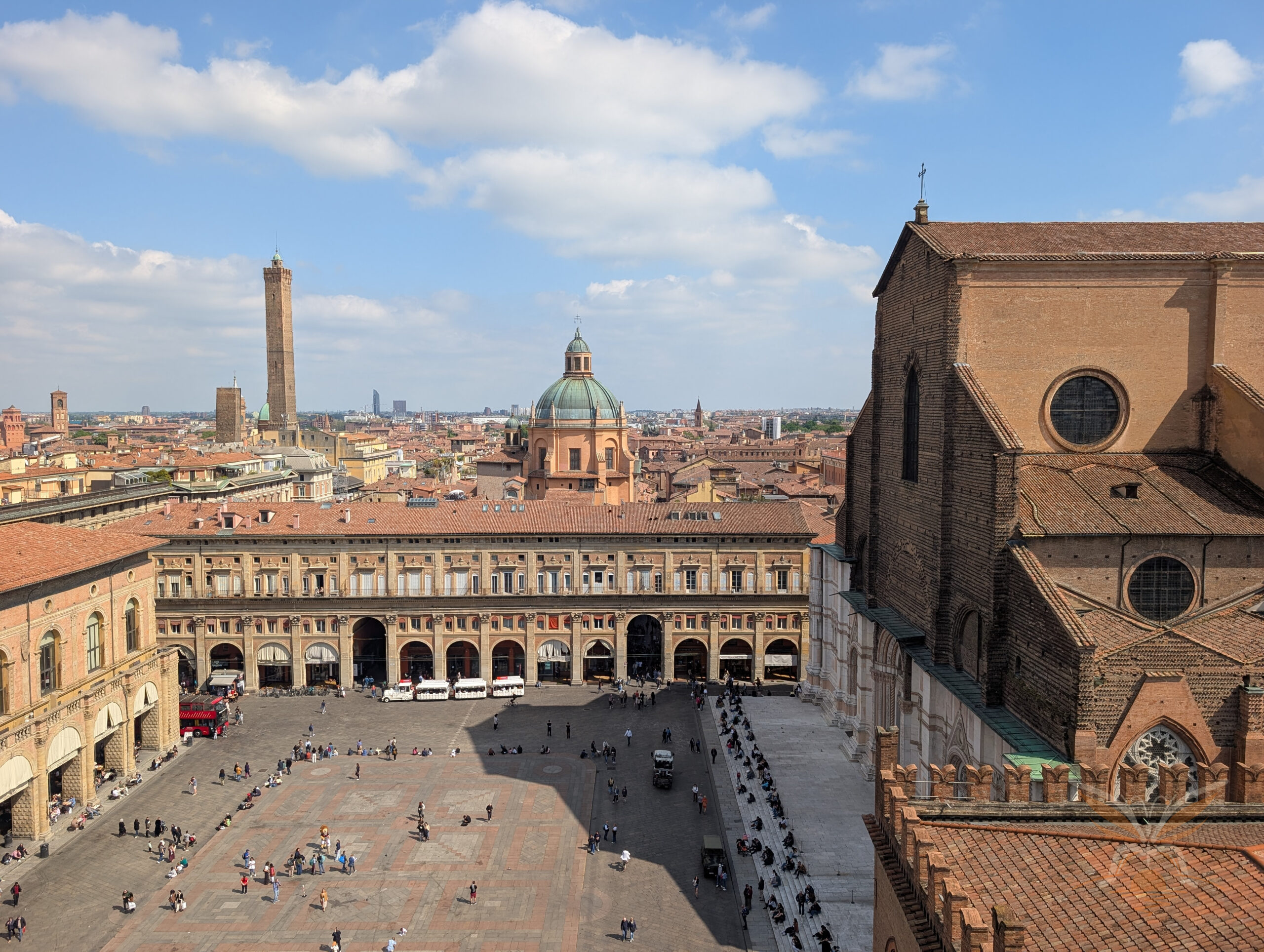 Panoramic view over Piazza Maggiore with the Basilica di San Petronio and Bologna’s historic rooftops.