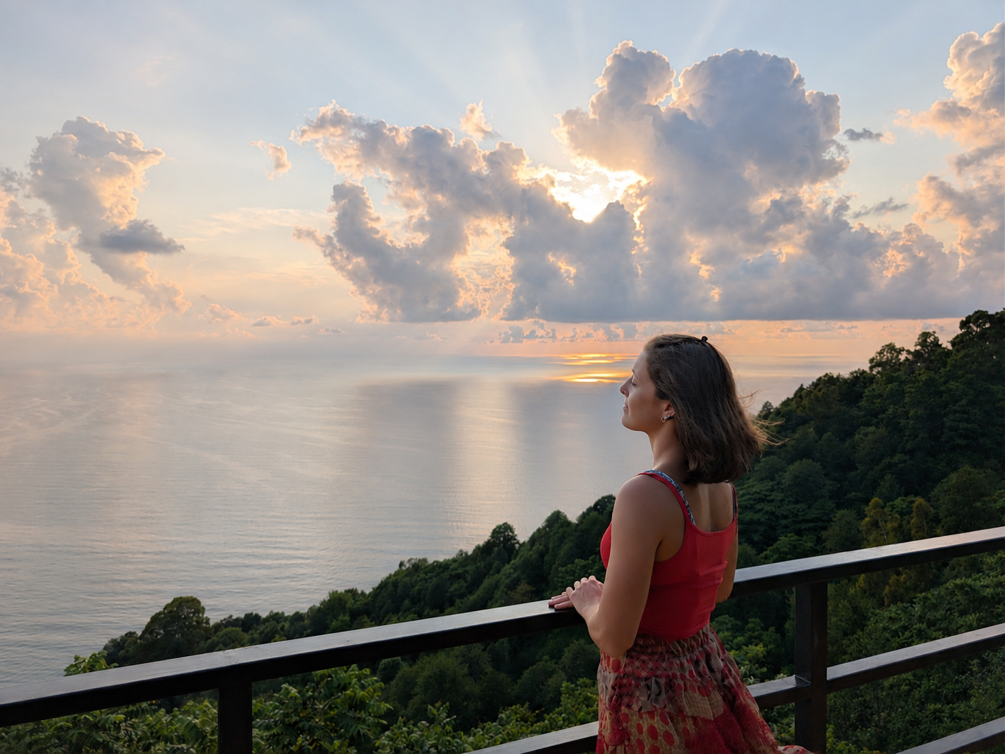 Mariachiara looking out over the sea at sunset.