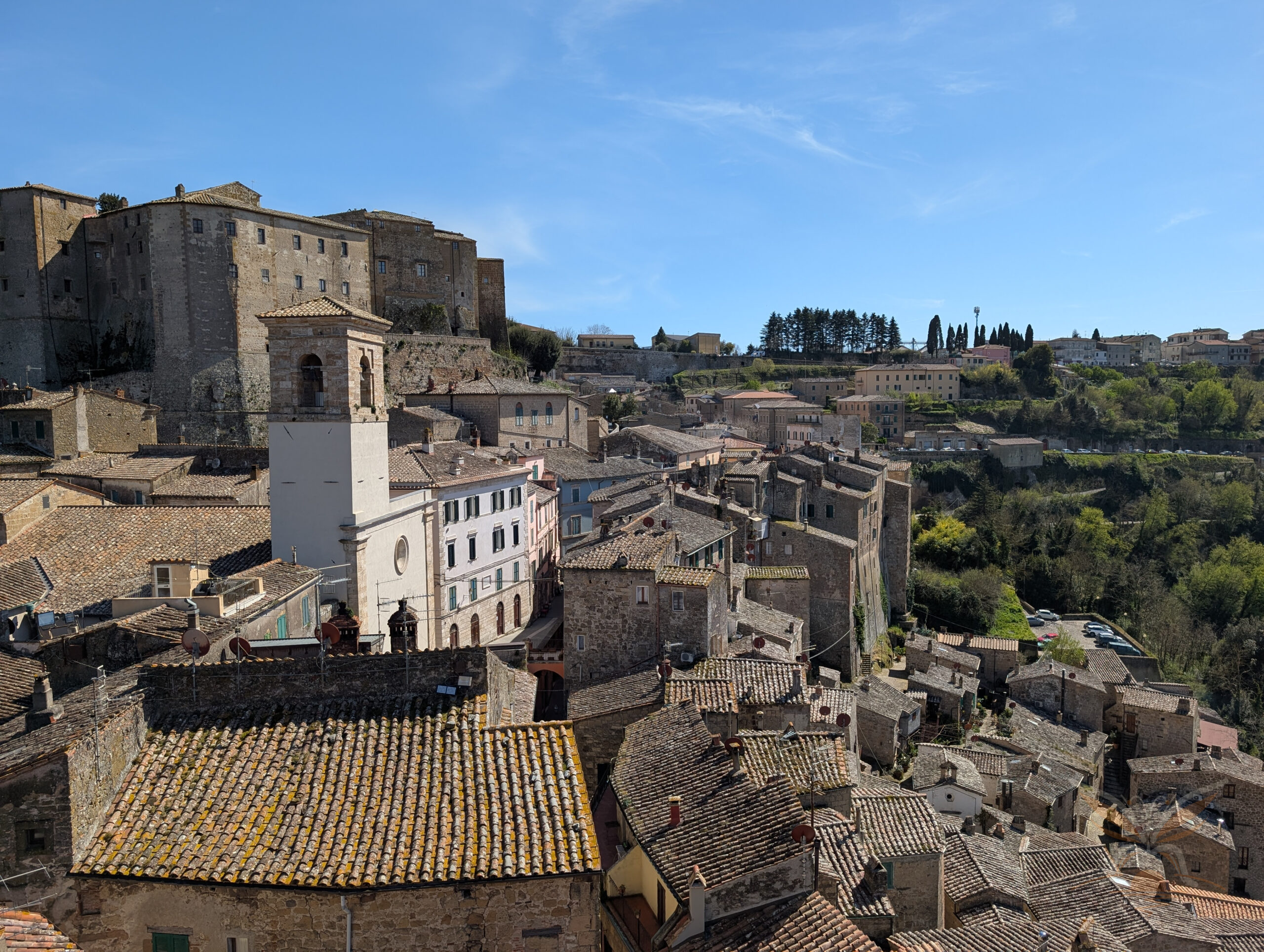 Panoramic view of Sorano’s stone houses, tiled rooftops and historic hilltop buildings in Tuscany.