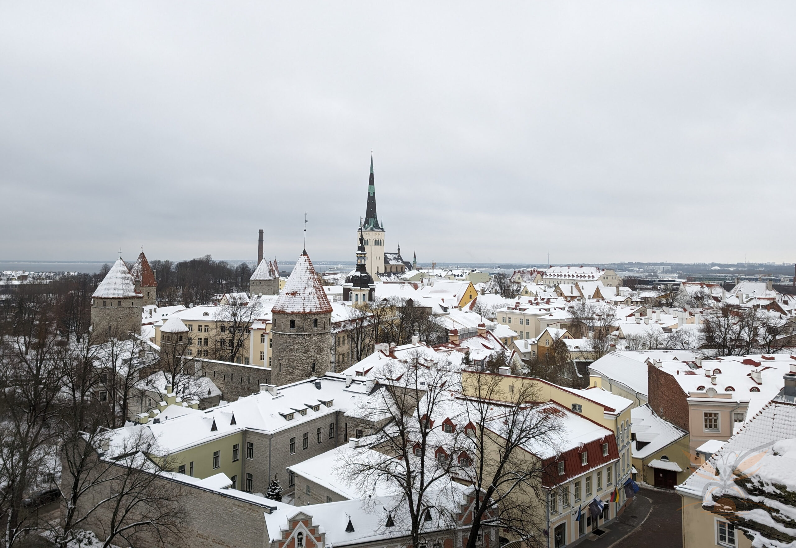 Snow-covered rooftops and church spires across Tallinn Old Town in Estonia.